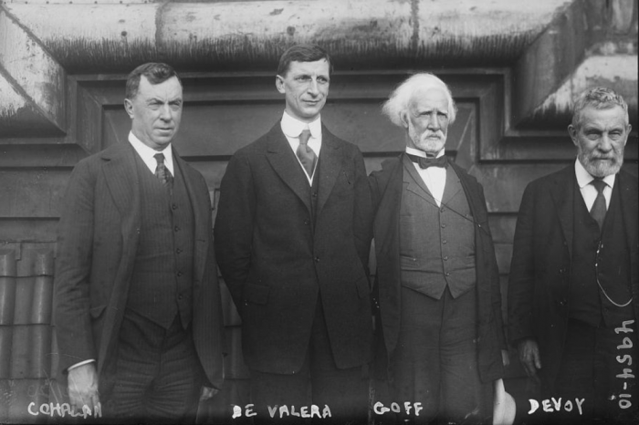 Four men in suits post for photo in 1919.
