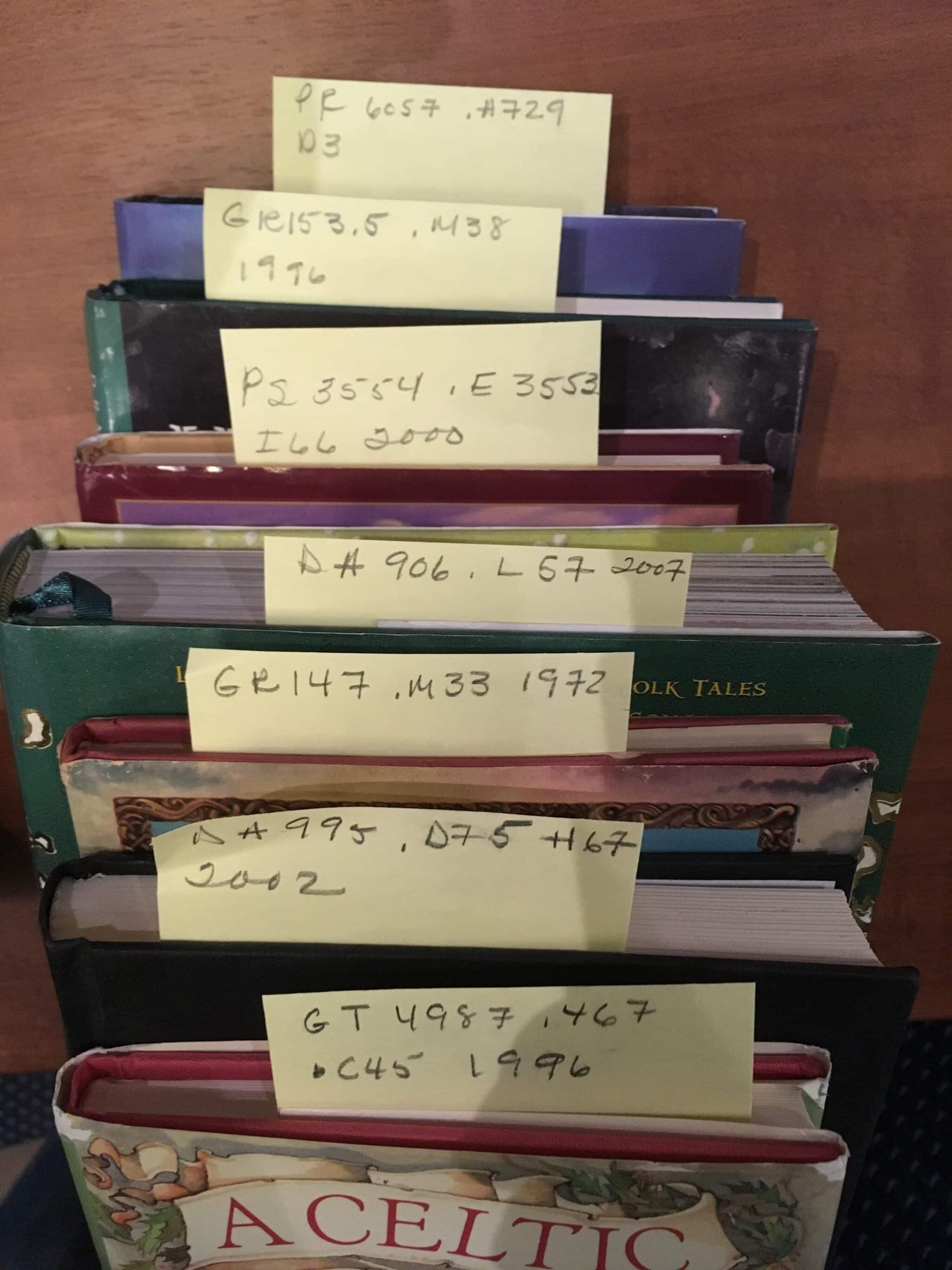 Stack of books w/ postits
