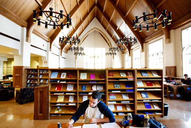 Vaulted ceiling, heavy iron light fixtures, and bookshelves all around make for a great place to study. 